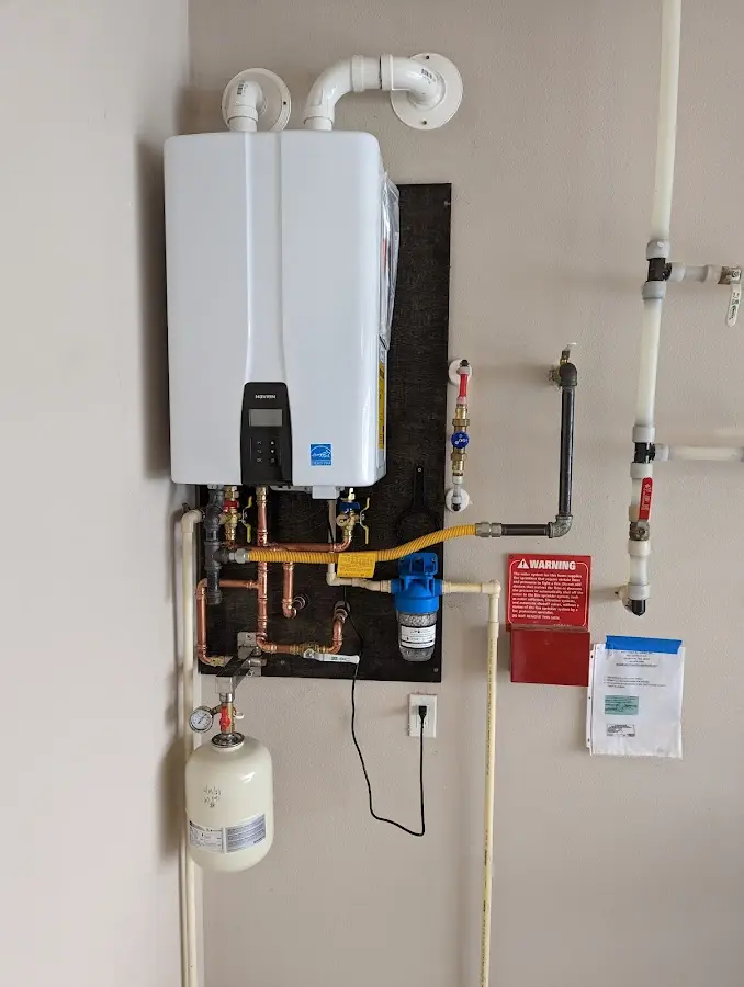 Professional plumber installing copper piping in a Fairmount home